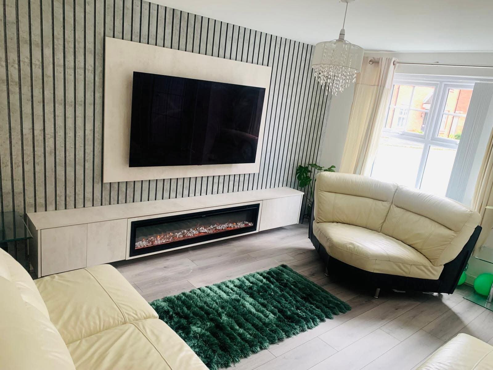 Bespoke media wall with electric fireplace, wood slat panels and floating cabinet