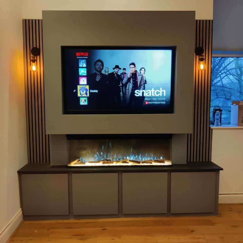 Grey media wall with TV, electric fireplace and decorative side lighting